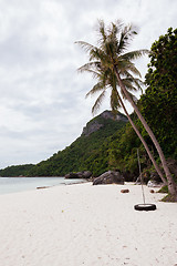 Image showing Beach on tropical island. Clear blue water, sand, clouds. 