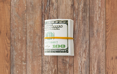 Image showing close uop of dollar money packet tied with rubber