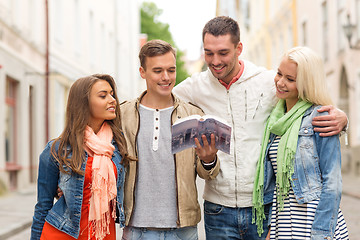 Image showing group of friends with city guide exploring town