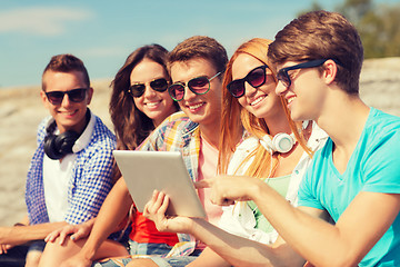 Image showing group of smiling friends with tablet pc outdoors