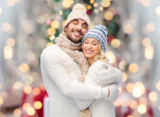 Image showing smiling couple in winter clothes hugging