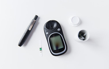 Image showing close up of glucometer and blood sugar test stripe