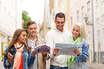 Image showing group of friends with city guide, map and camera