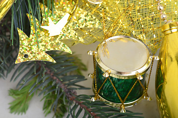 Image showing Christmas background with drums, green eve tree branch, golden new year decoration 