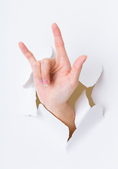 Image showing Peace sign gesture break through the paper wall