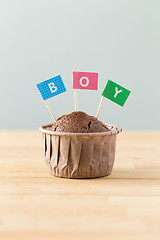 Image showing Chocolate muffins with small flag of a word boy