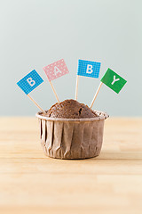 Image showing Chocolate muffins with small flag of a word baby
