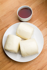 Image showing Steamed chinese bun with a cup of tea