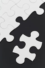 Image showing White puzzle on black background