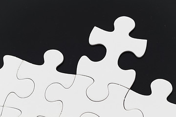 Image showing White puzzle on black background