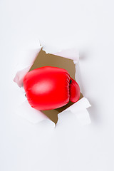 Image showing Punching boxing glove though over white paper