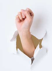 Image showing Arm fist breaking through the paper wall