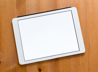 Image showing Digital Tablet on a desk and showing a blank screen for advertis