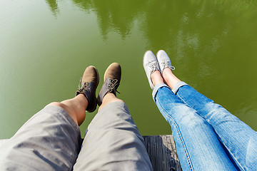 Image showing Couple legs wite lake