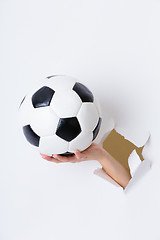 Image showing Hand break through paper with soccer ball