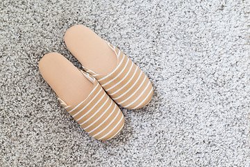 Image showing Pair of slippers on carpet