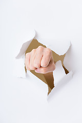 Image showing Fist punching through paper