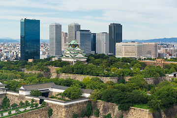 Image showing Osaka castle with business building