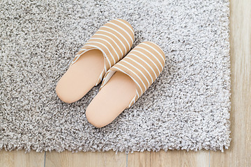 Image showing Slippers on grey carpet