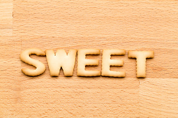 Image showing Word sweet cookie over the wooden background