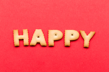 Image showing Happy word cookie over the red background