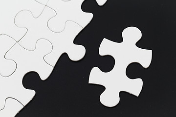 Image showing Jigsaw pieces isolated on black Jigsaw and puzzles concepts