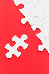 Image showing Jigsaw puzzle over the red background