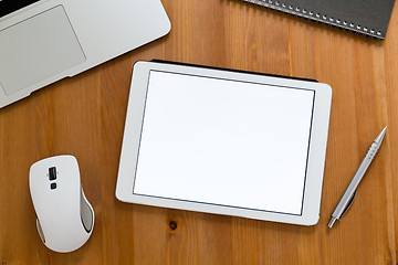 Image showing Modern working desk with tablet showing a blank screen for adver