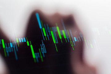 Image showing Touching stock market graph on a touch screen device