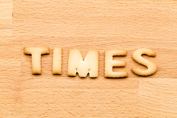 Image showing Word times biscuit over the wooden background