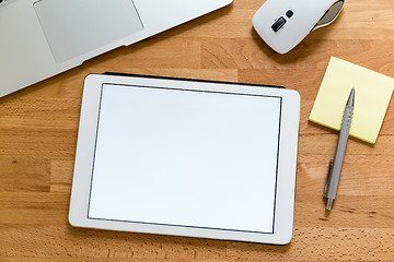 Image showing Business office table with table pc presenting a blank screen fo