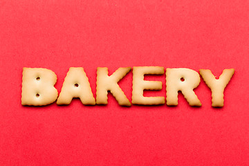 Image showing Word bakery biscuit over the red background