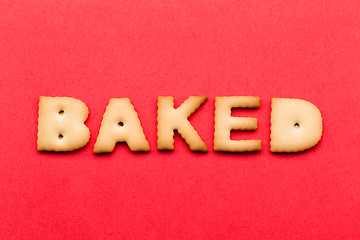 Image showing Word baked biscuit over the red background