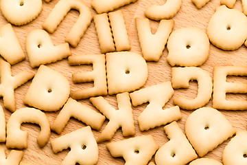 Image showing Baked word biscuit over wooden table