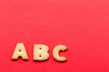 Image showing ABC biscuit over the red background