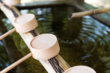 Image showing Traditional purification ladles at entrance to Japanese temple