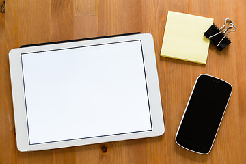 Image showing Working desk with digital tablet showing a blank screen for adve