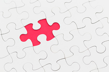 Image showing Plain white jigsaw puzzle on Red background