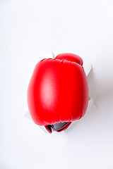 Image showing Hand in boxing glove through paper hole