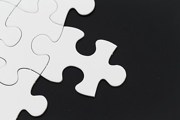 Image showing Plain white jigsaw puzzle on Black background