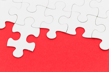 Image showing Jigsaw puzzle over red background