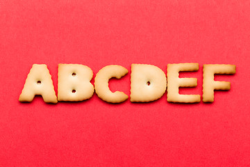 Image showing ABCDE biscuit over the red background