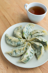 Image showing Chinese meat dumpling with a cup of tea