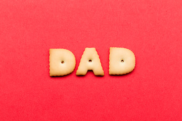 Image showing Word dad biscuit over the red background