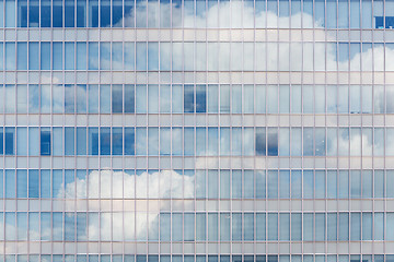 Image showing Cloud reflected in windows of modern office building