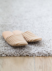 Image showing Striped slippers on carpet background