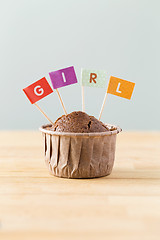 Image showing Chocolate muffins with small flag of a word girl