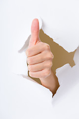 Image showing Thumb up hand gesture break through the paper wall