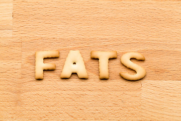 Image showing Word fats biscuit over the wooden background
