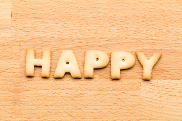 Image showing Word happy cookie over the wooden background